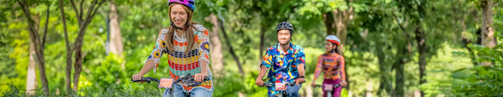 friends-riding-bikes-blue-care.webp