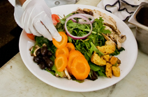 A colorful salad plate includes a variety of vegetables.